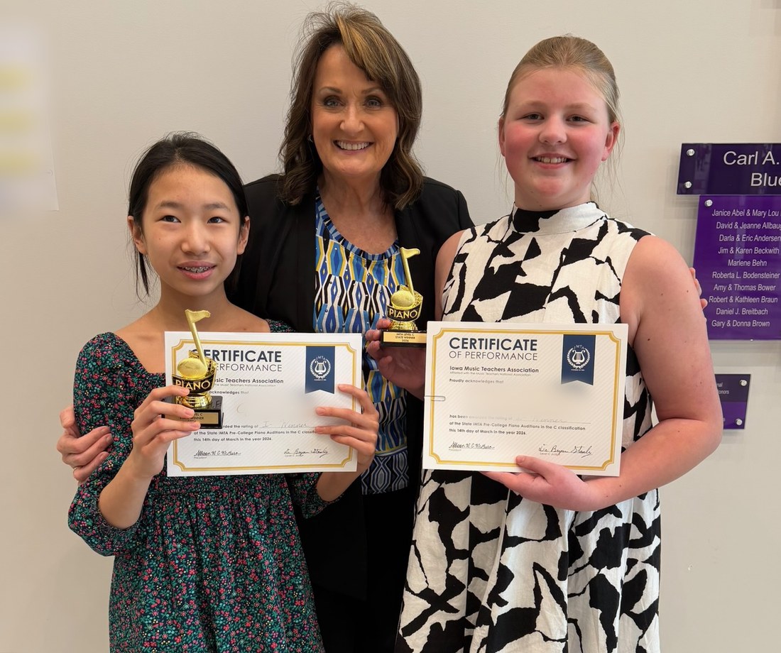 Cyndie Caruth with two Caruth Piano Studio students holding state audition awards